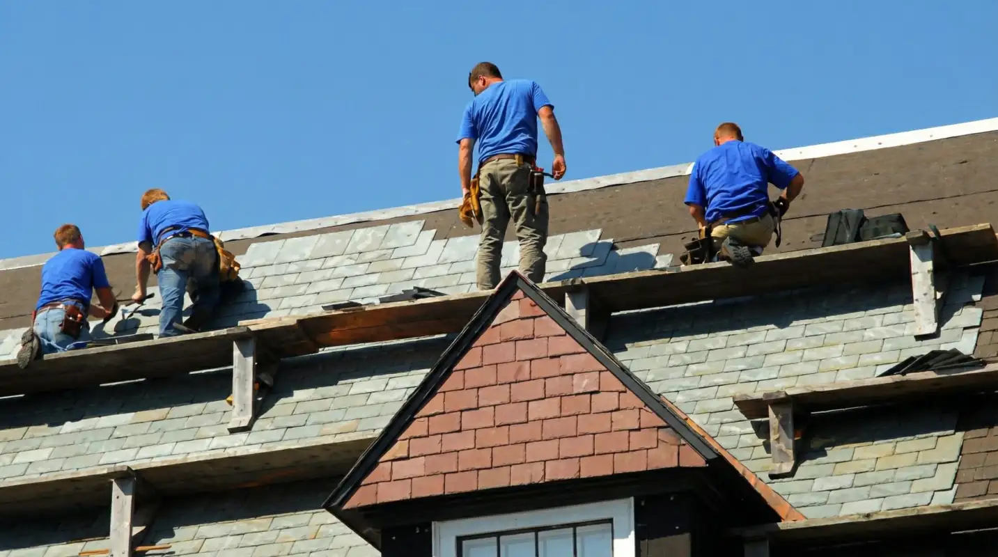 Roof replacement in progress with a team of professional contractors installing new shingles on a residential home in Little Rock, AR