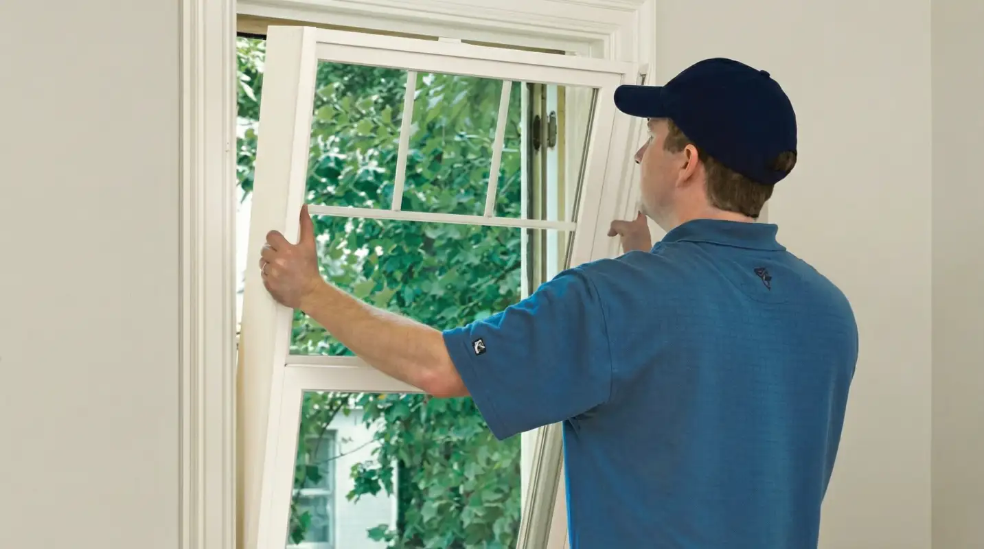 Professional contractors performing a residential window insulation and replacement service in Little Rock, AR